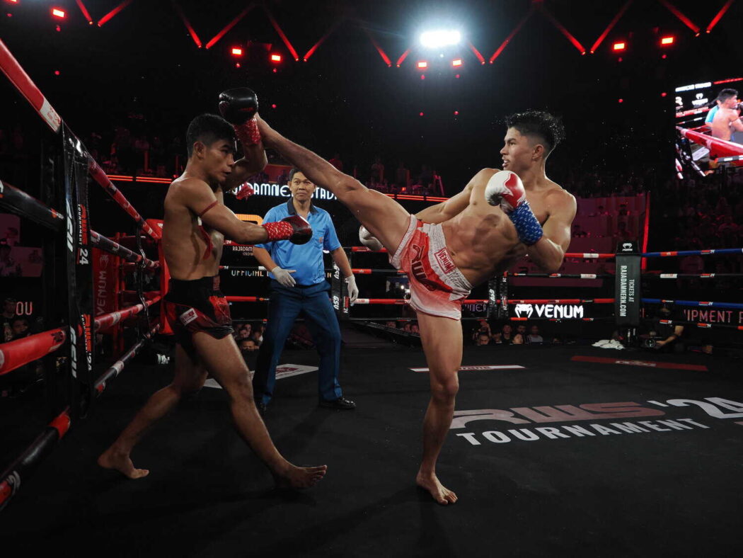 Muay Thai fighter blocks a high kick from his opponent