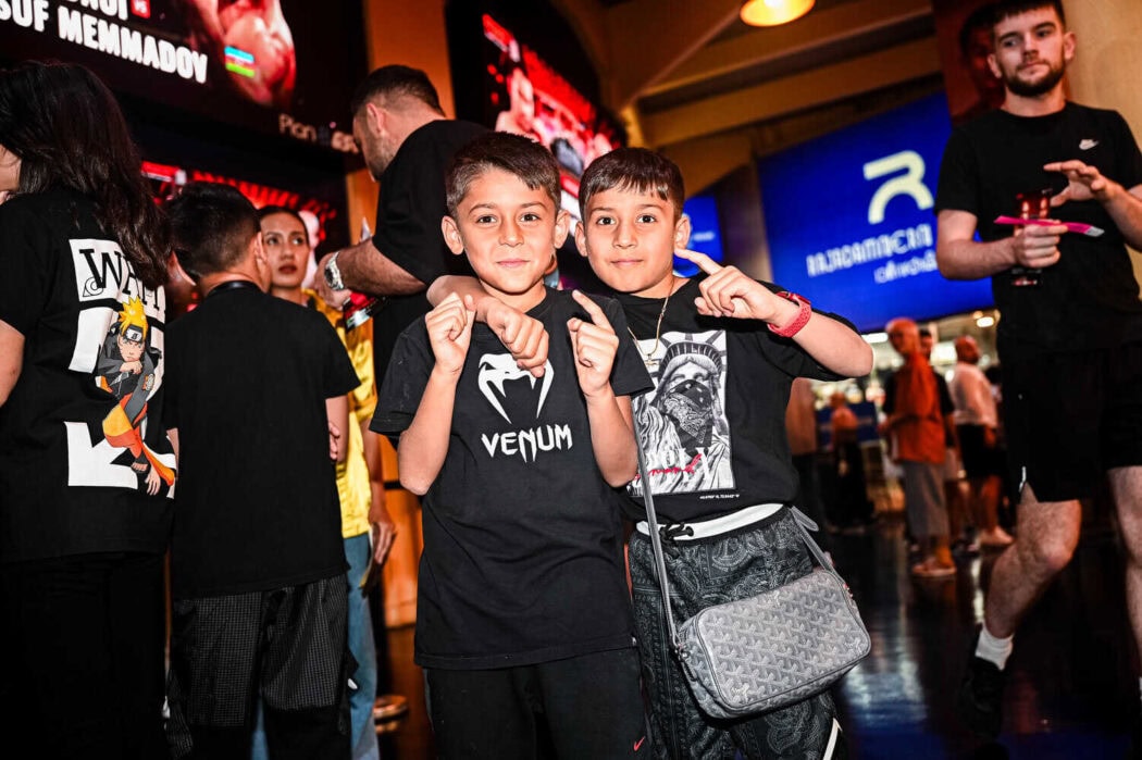 Two boys waiting for the fight to start at Rajadamnern Stadium