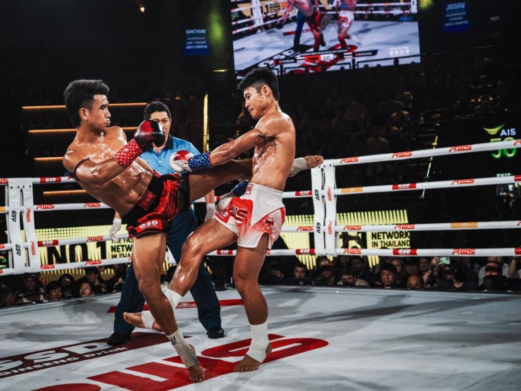 Elite Muay Thai fighters showcase powerful kicks during a live match