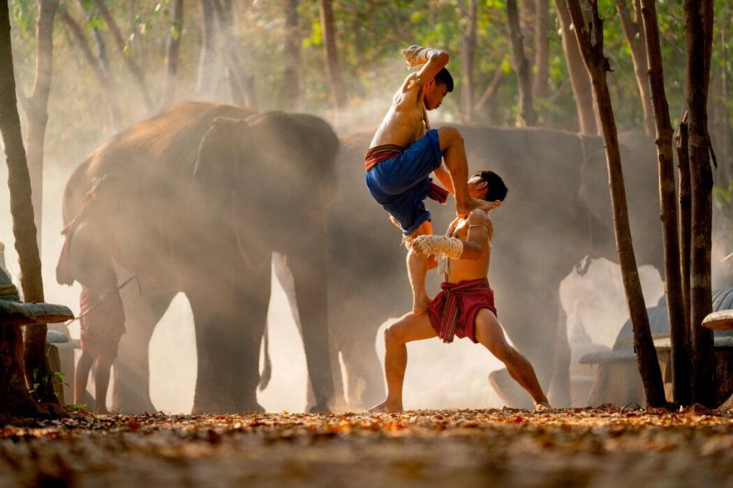 Two fighters demonstrating Muay Boran techniques, the ancient martial art behind Thai traditional sports
