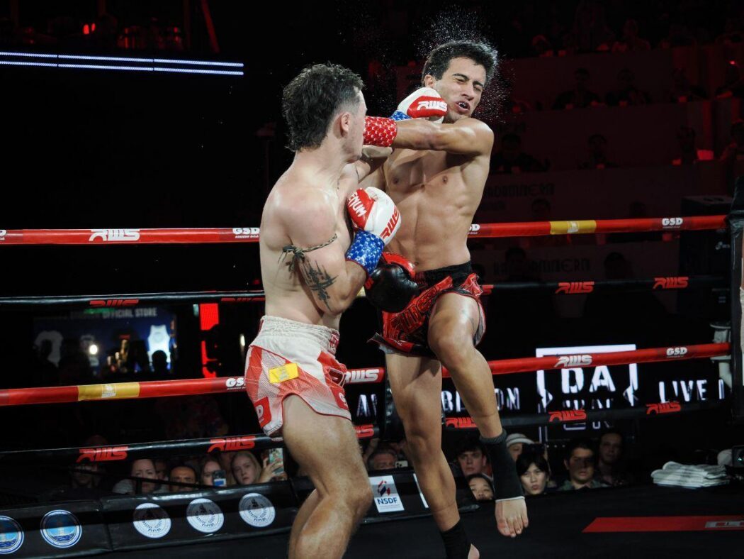 a muay thai boxer delivers a jab after a successful long guard