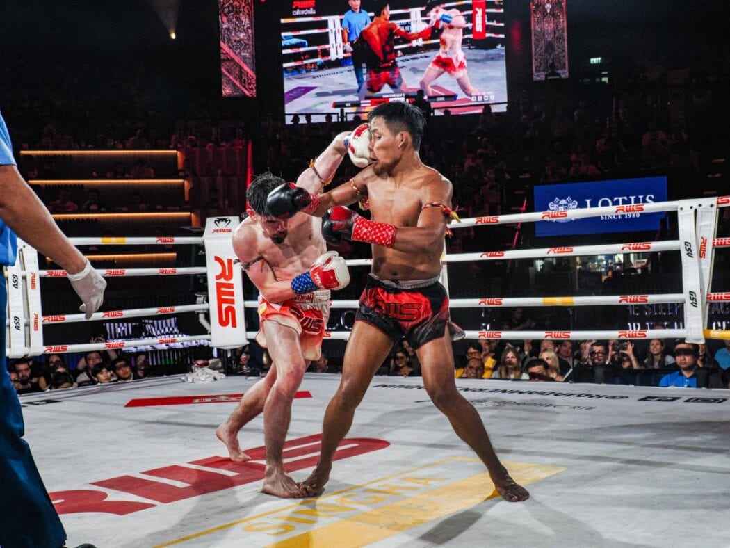 fighter in a southpaw stance lands a devastating left hook on an opponent